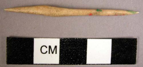 Small double pointed bone implement