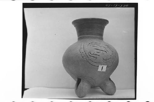 Plumbate standard jar, tripod legs, incised medallion.