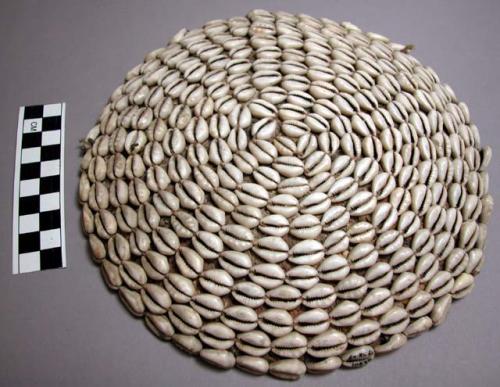 Flat basket covered with cowrie shells, 8.5" across