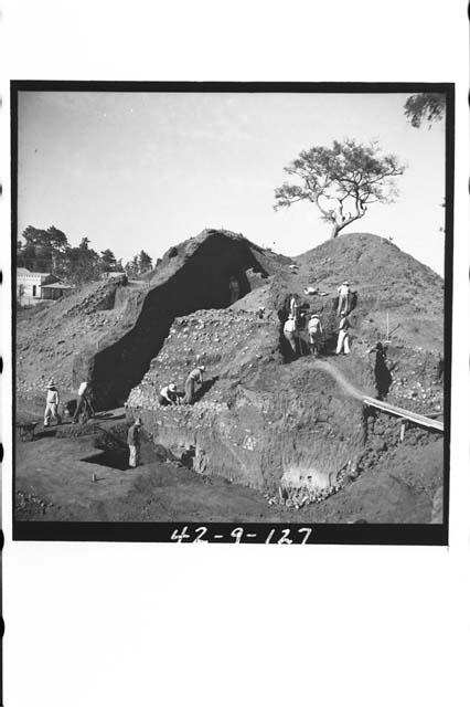 General view of workers excavating mound