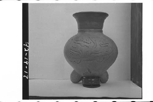 Plumbate standard jar, tripod legs, incised medallions.