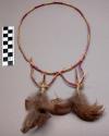 Feathered headdress, cerise and natural colored straw band