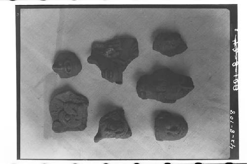 Seven fragments of pottery heads
