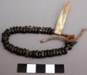 Fourty brass beads strung on sturdy cord
