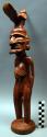 Standing male figure, wood, with bird headdress, 15 in. h,  Said to have been pu
