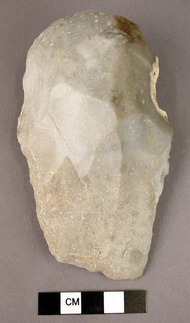 Stone cleaver made on end-struck flake: U-shaped butt, oblique cutting edge;