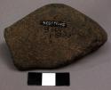 Ground stone object, broken, pitted