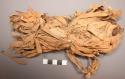 Piece of cedar bark wrapped in corn husks