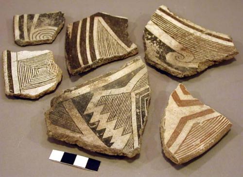 Ceramic rim and body sherd, black on white, red on white, geometric designs