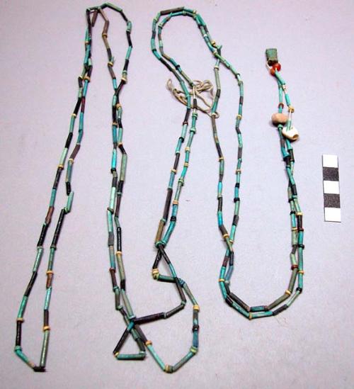 String of pottery beads with 3 pendant charms