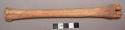 Bone shaft, deeply incised lengthwise one side, partially incised opposite side