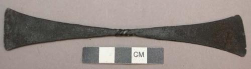 Flat metal knife; double bladed, with identical triangular ends joined by a thic