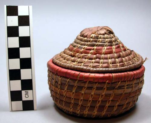 Basket, coiled veg fiber, red, brn, purple bands, flat base, concave conical lid