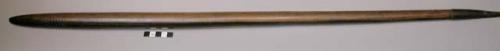 One narrow throwing stick of heavy brown wood