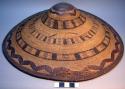 Coiled basketry hat, with leather binding at rim; additional 3 strand leather zi