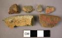 Ceramic rim and body sherds, buff, red, and black slipped