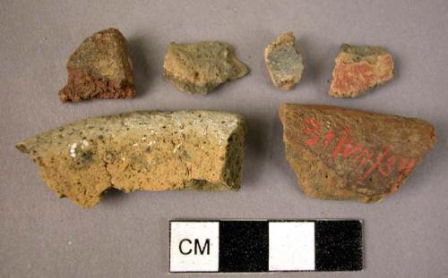 Ceramic rim and body sherds, buff, red, and black slipped