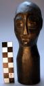 Figurine, carved wood, human head, incised facial features, hole in top of head