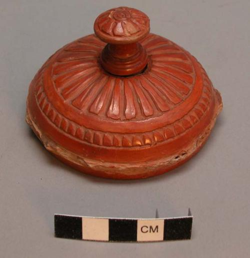 Ceramic lid to container, w/ broken handle, carved & incised linear design.
