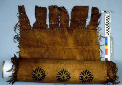 Tapa cloth with black designs and fringe