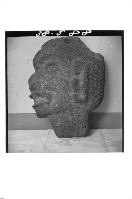 Flat stone head (left profile)