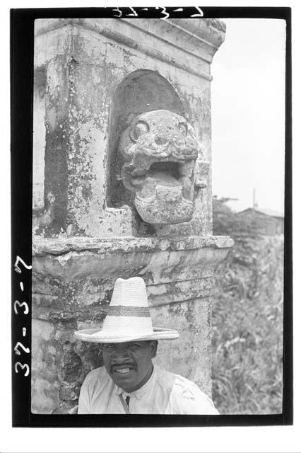 Man next to sculptured jaguar on bridge