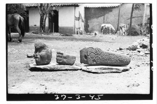 Three scuptures (head, hand, + ?) in Pension Ferrocarril