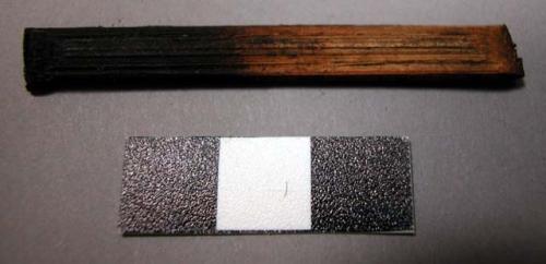 Reed fragment, angled one end, burnt