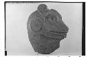 Flat stone head in animal form.  Perhaps head of jaguar.