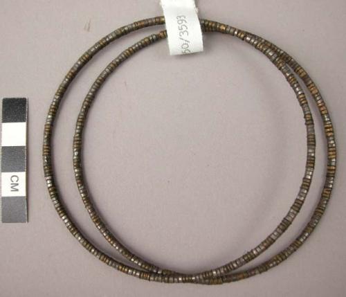 Leglets - circular strip of fibre with occasional bands of brass and copper (ndi