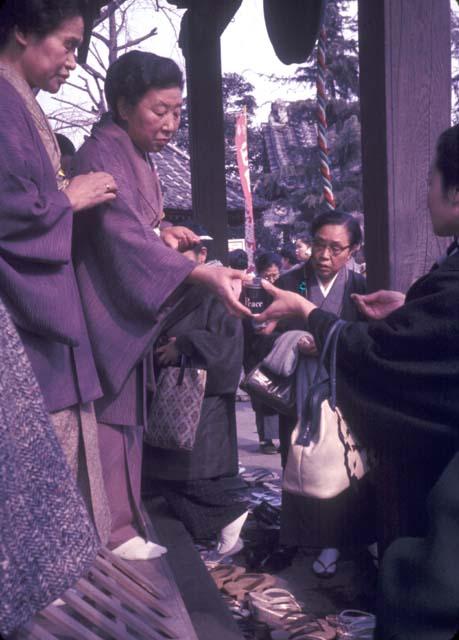 Woman handing in broken needles, Hari Kuyo