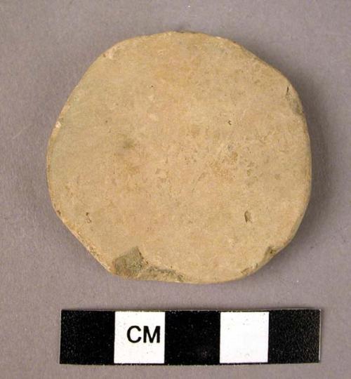 Ceramic body sherd, undecorated white ware, re-shaped into disc