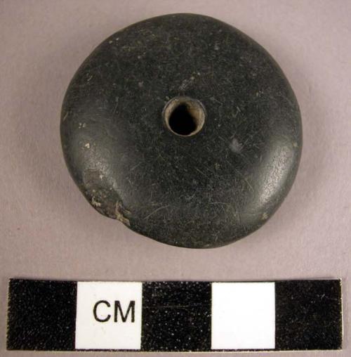 Discoidal dark grey stone spindle whorl