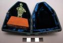 Small bronze figure on wooden stand with blue, velvet-lined case.