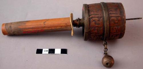 Metal prayer wheel containing paper with writing - wooden handle