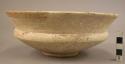 Carinate pottery bowl - flaring rim; cream slip low ring base;