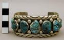 Cuff bracelet, silver band w/ rolled edges, set with turquoise nuggets