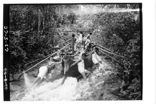 Boat being pushed up rapids