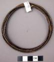 Leglets - circular piece of fibre wound with strips of copper, brass, and iron (