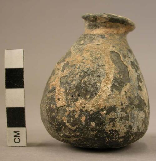 Narrow mouthed conical pottery vessel with flatly rounded base;