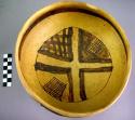 Fine geometric black-on-yellow pottery bowl