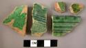 Ceramic rim and body sherds, buff ware with green glaze, some decorated