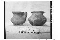 2 tetrapodal pottery jars