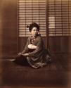 Young Japanese woman in traditional dress, seated