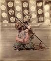 Japanese theater performer in full costume and mask, with spear