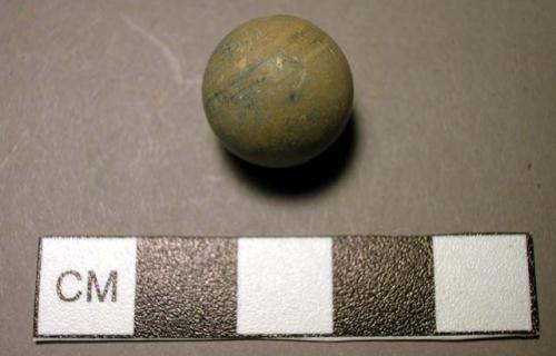 Small tan ball, possibly shot or child's marble; modern