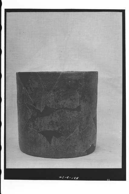 Brown-black cylindrical vase (R-205) from Tomb cache.