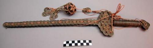 Ornamental sword made of japanese coins lashed together with string