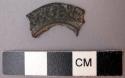 Fragment of circular bronze? object with floral design in relief