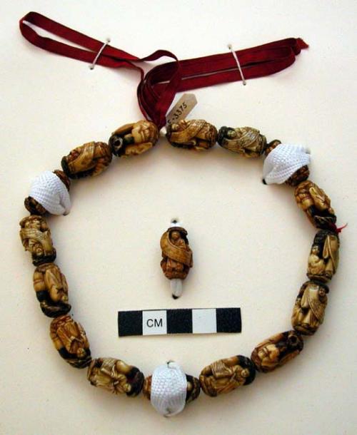 Red ribbon string of carved ivory beads - 16 beads and 1 loose bead